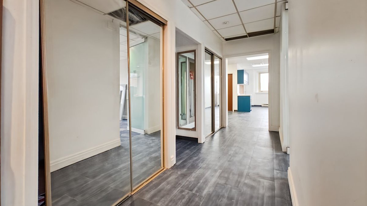 Corridor with glass-fronted private offices at 39 Queen St in downtown St. Catharines